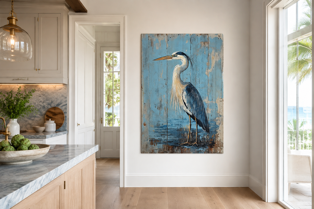 Rustic blue heron painting on weathered wood-textured canvas in a coastal kitchen setting.