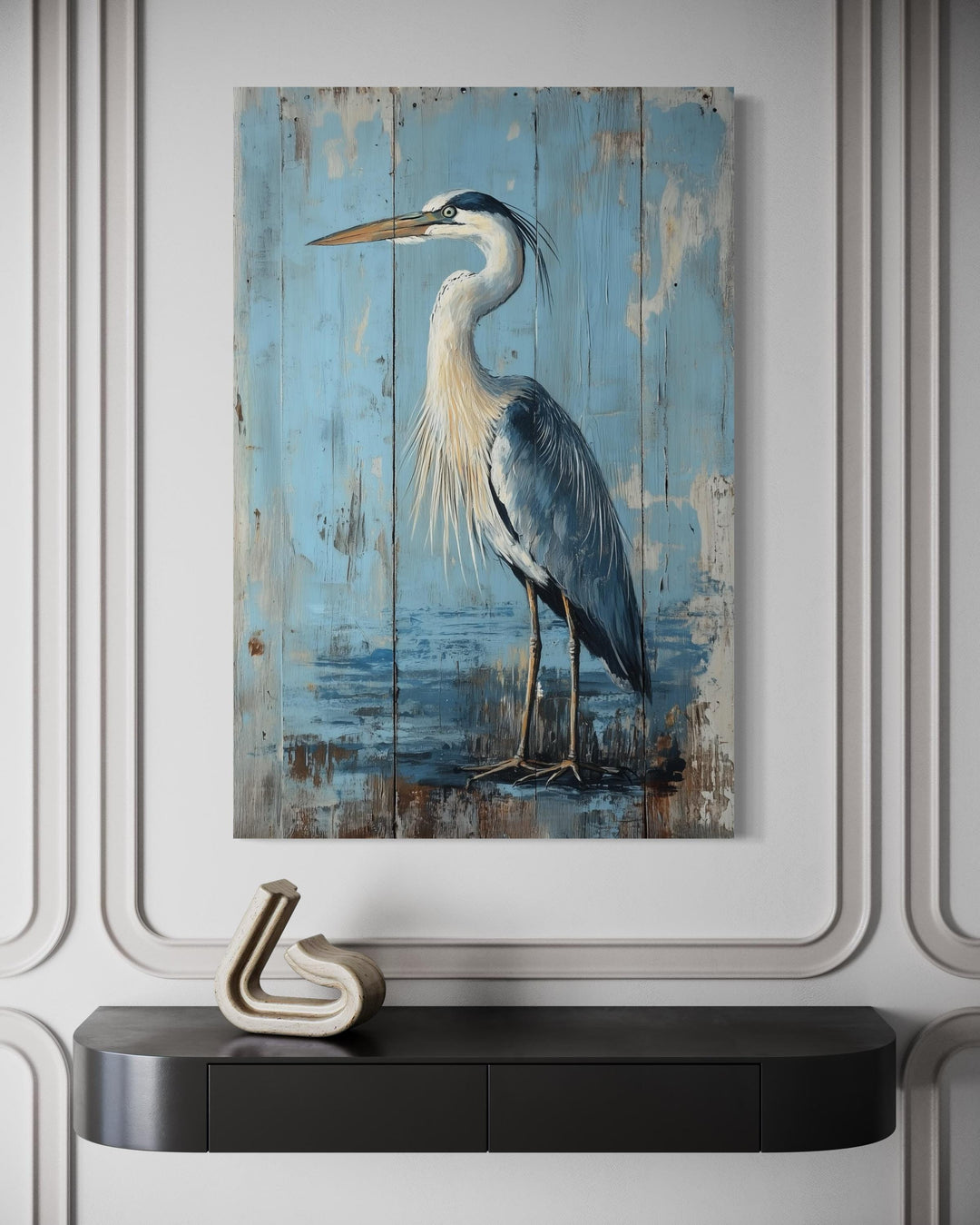 Rustic blue heron painting on a weathered wood-textured canvas above a black console table.