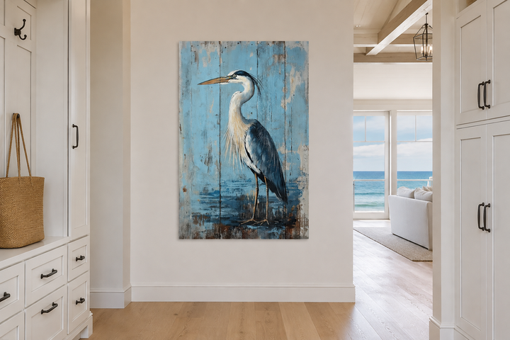 Blue heron painting on rustic wood-textured canvas wall art in a coastal hallway.