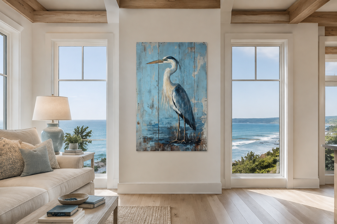 Blue heron painting on rustic wood-textured canvas wall art in a coastal living room setting.