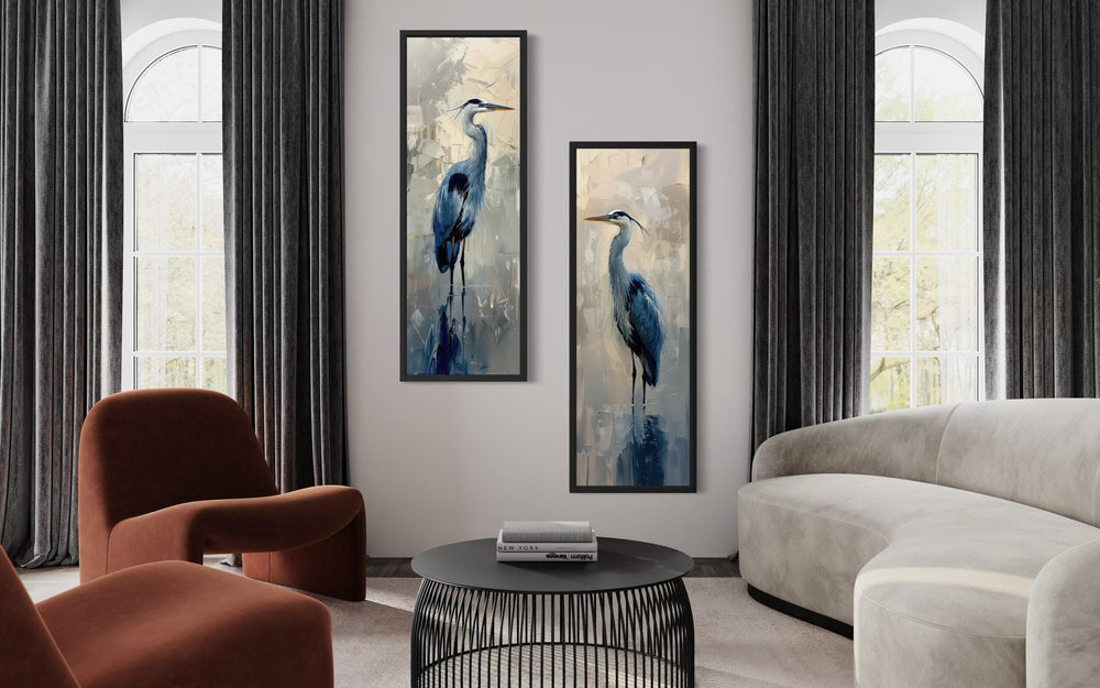 Set of two tall narrow canvas prints featuring blue herons in a modern living room.