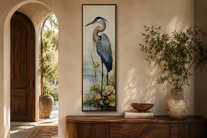 Tall narrow vertical framed canvas wall art featuring a detailed blue heron in a coastal setting.