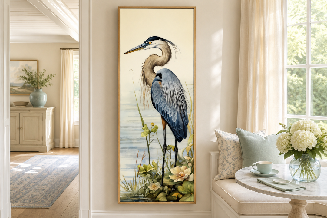 Tall narrow vertical framed canvas wall art featuring a detailed blue heron in a coastal setting.