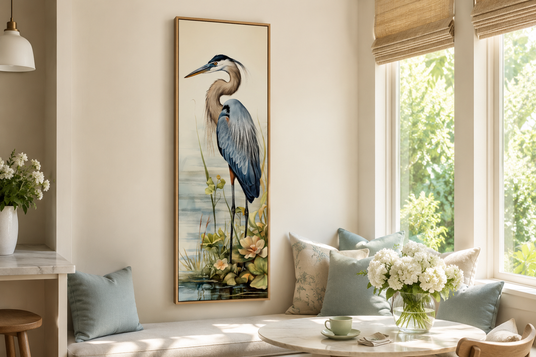 Tall narrow vertical framed canvas wall art featuring a detailed blue heron in a coastal setting.
