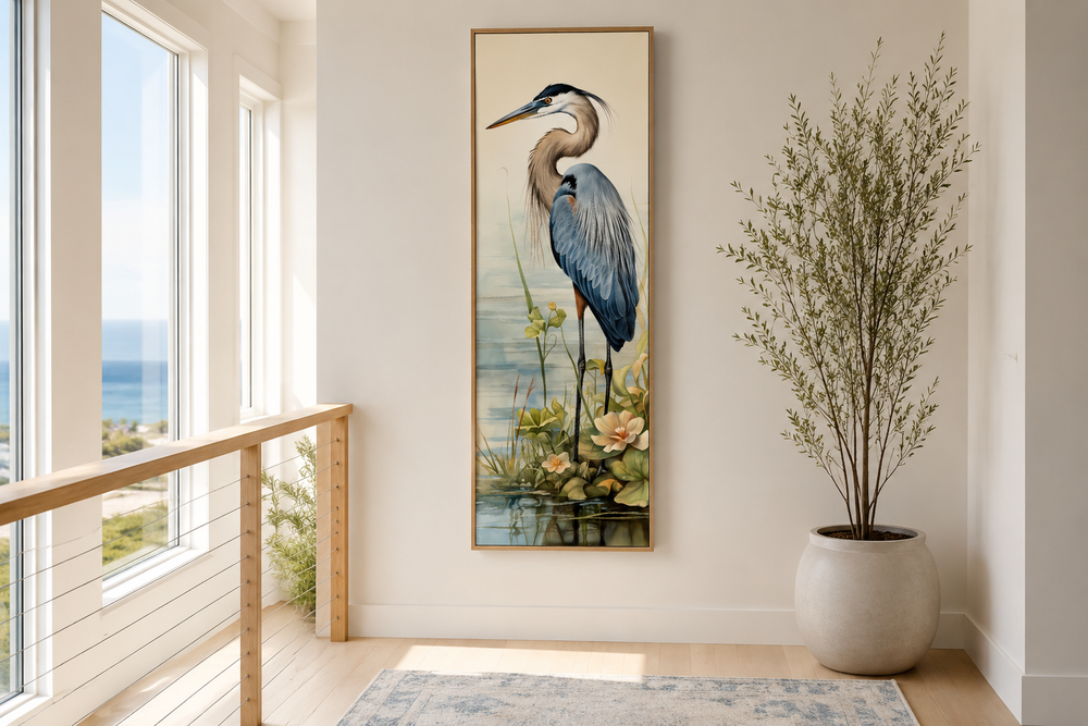 Tall narrow framed canvas wall art featuring a blue heron in a serene coastal landscape.