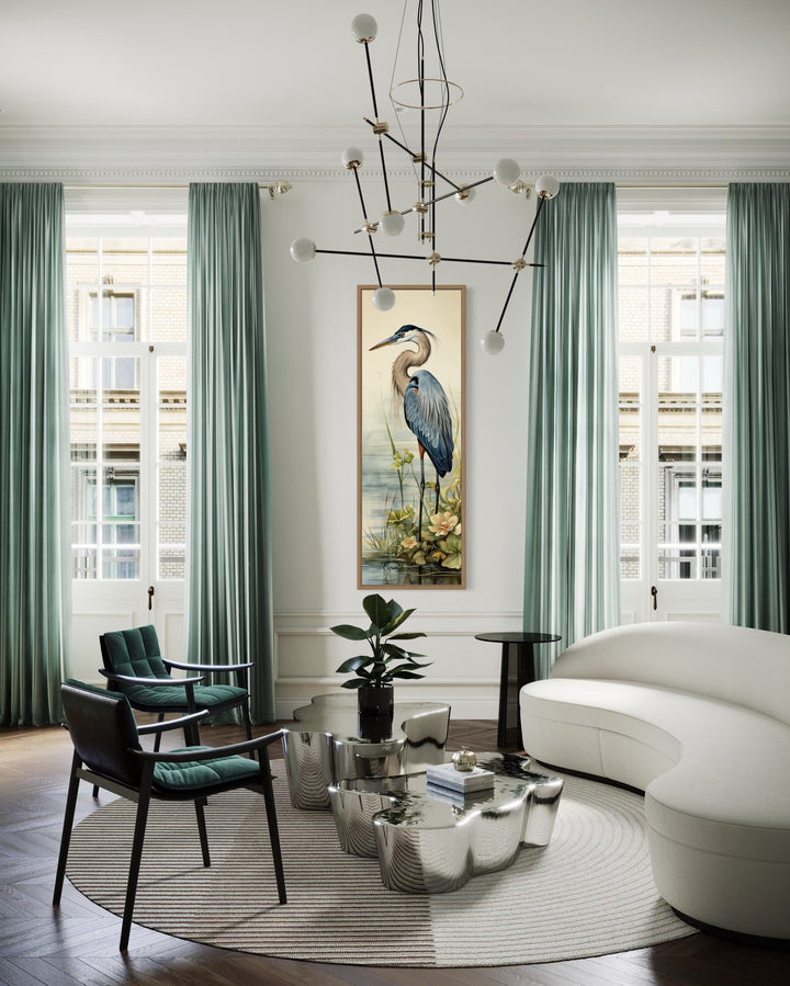 Tall narrow framed canvas wall art featuring a blue heron in a serene coastal landscape.