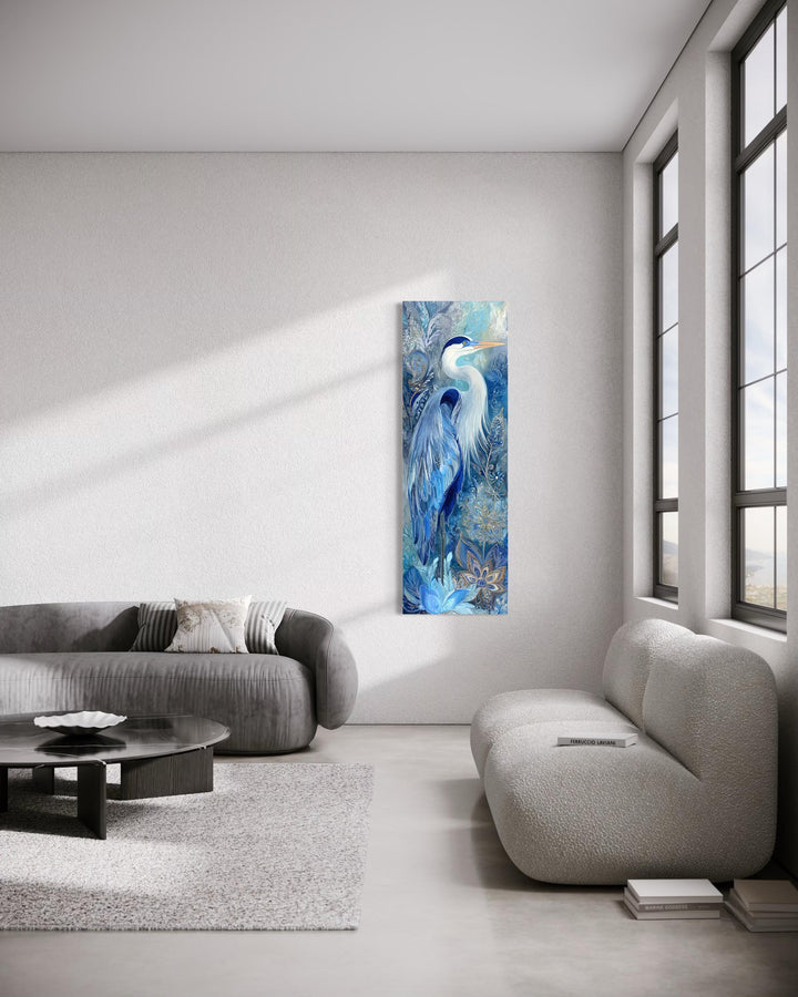 Tall narrow canvas print of a blue heron in a modern living room with minimalist furniture.