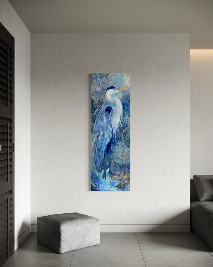 Tall narrow canvas print of a blue heron with intricate patterns on a minimalist white wall.