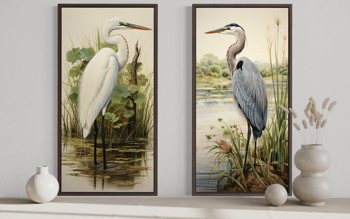 Two framed canvas prints featuring a great blue heron and a white egret in a lush wetland setting.