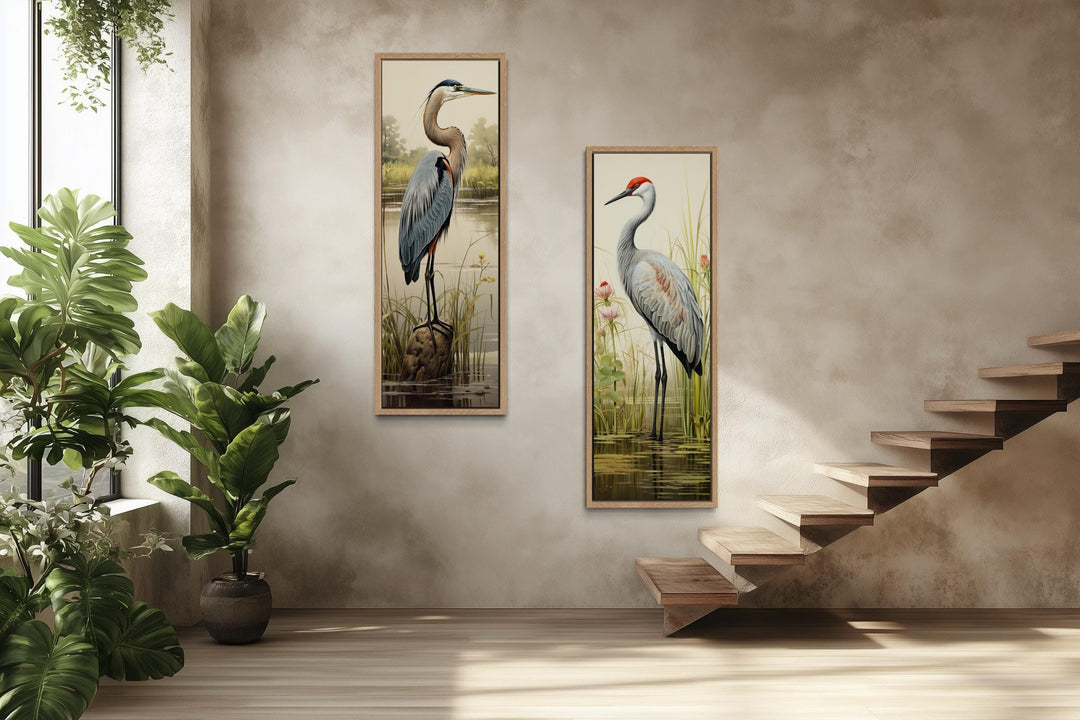 Set of two tall vertical canvas prints featuring a blue heron and a sandhill crane in marshlands.