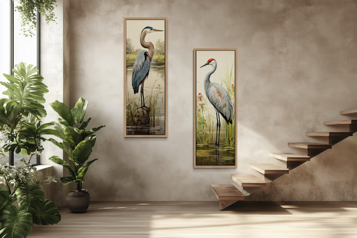 Set of two tall vertical canvas prints featuring a blue heron and a sandhill crane in marshlands.