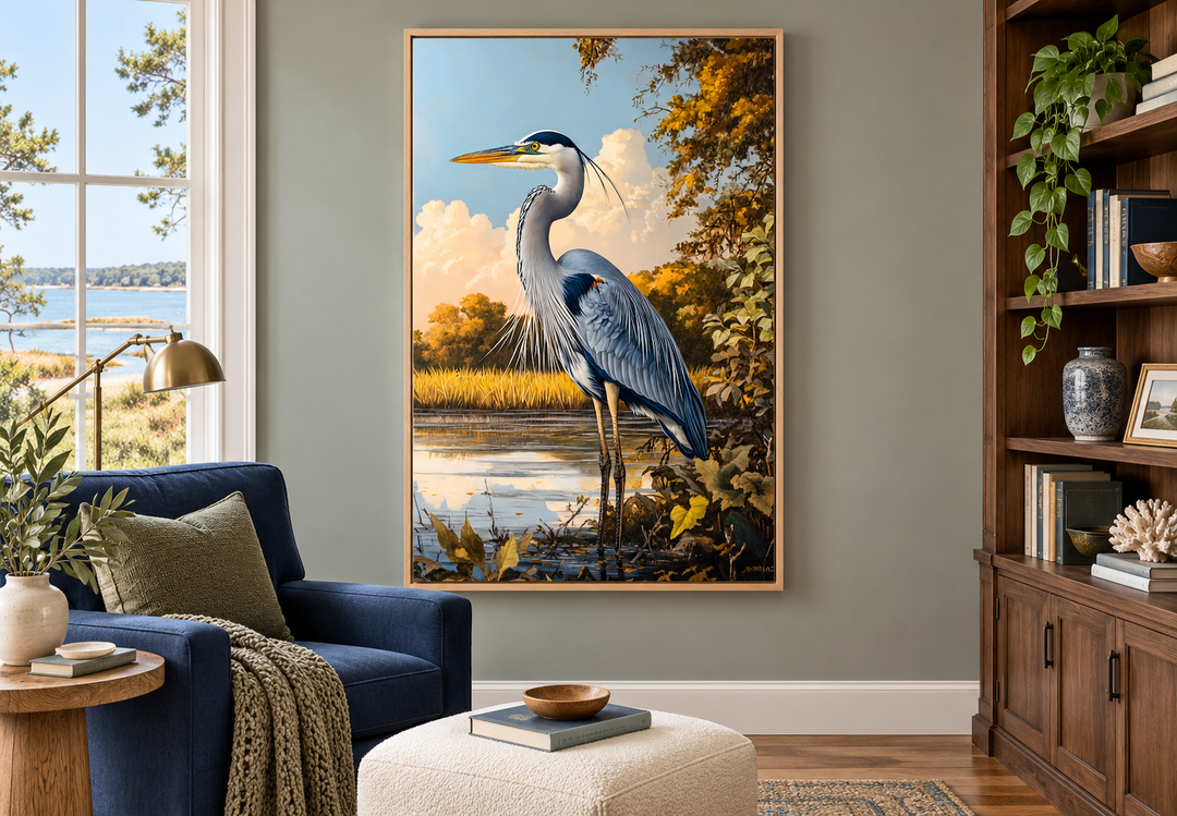 Great blue heron in marshland framed canvas wall art hanging in a coastal-style living room.