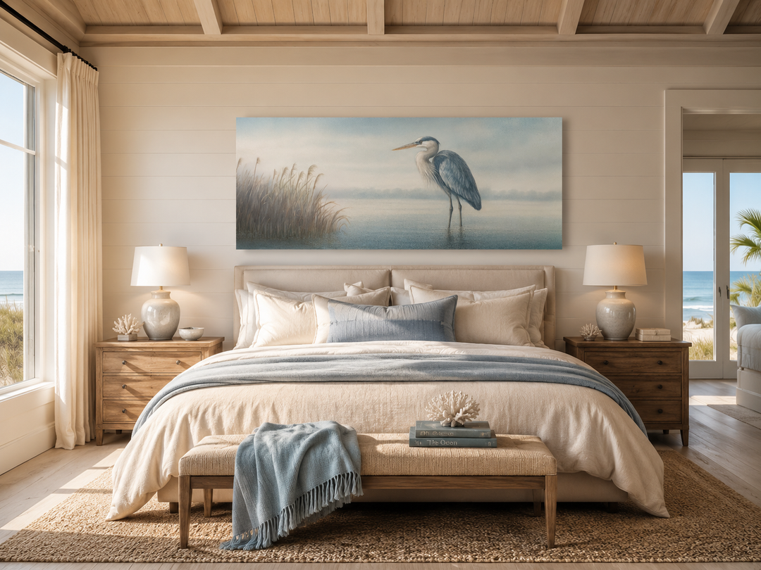 Blue Heron in Misty Lake framed canvas wall art hanging above a bed in a coastal-style bedroom.