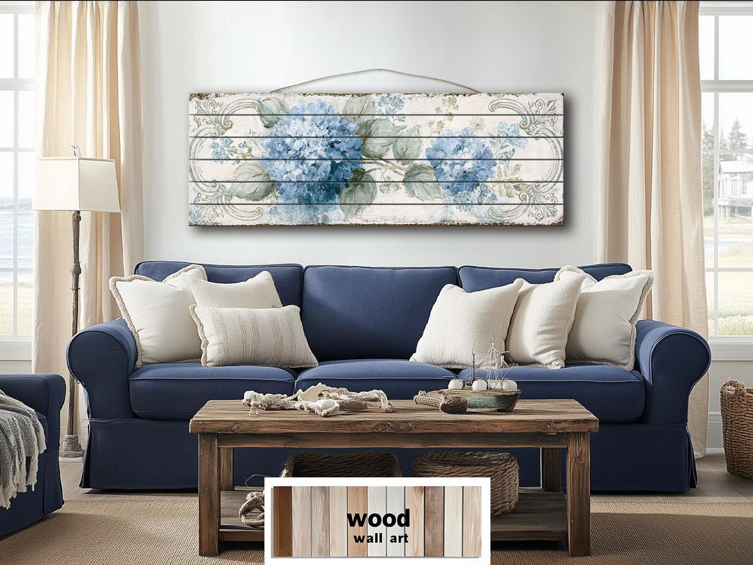 Blue hydrangea floral design printed on horizontal distressed wood planks above a blue sofa.