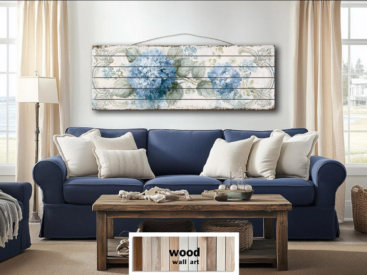 Blue hydrangea floral design printed on horizontal distressed wood planks above a blue sofa.