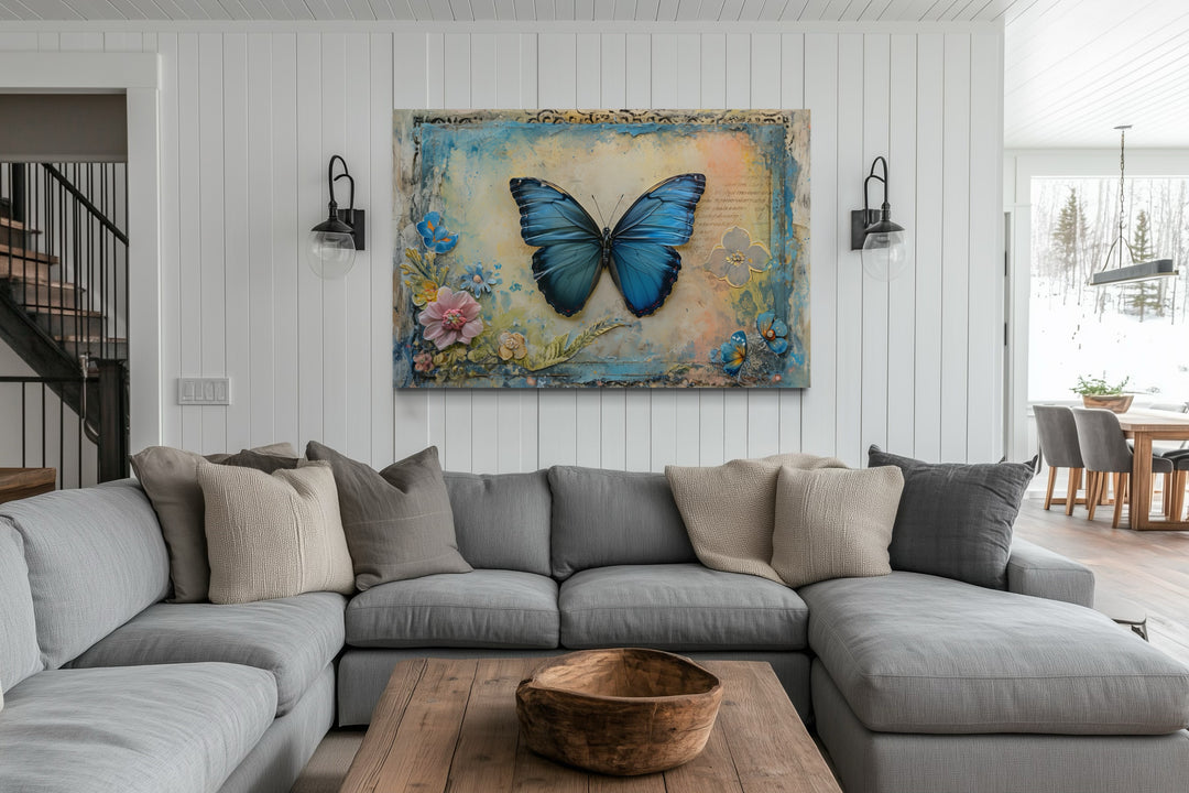 Blue Monarch Butterfly Vintage Framed Canvas Wall Art hanging above a grey sectional sofa.