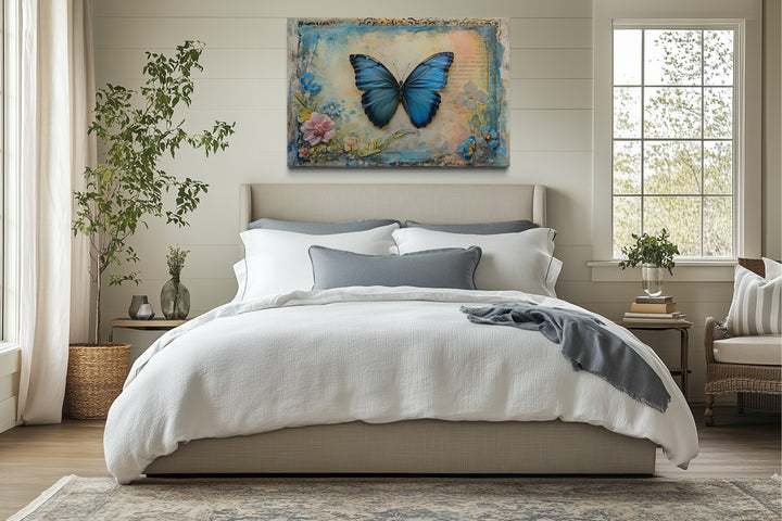 Blue Monarch Butterfly Vintage Framed Canvas Wall Art hanging above a bed in a rustic bedroom.