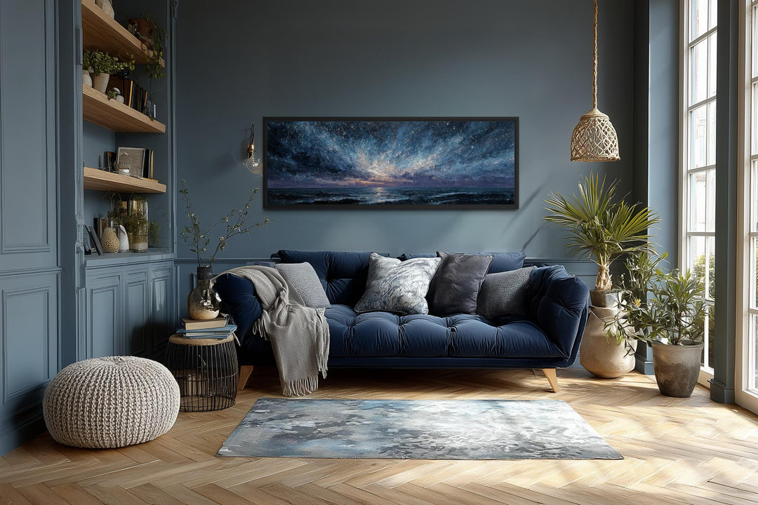 Panoramic moody seascape canvas print featuring navy and purple tones above a dark blue sofa.