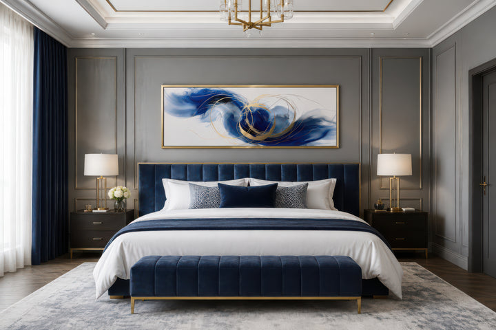 Blue, white, and gold minimalist abstract horizontal canvas art hanging above a bed.