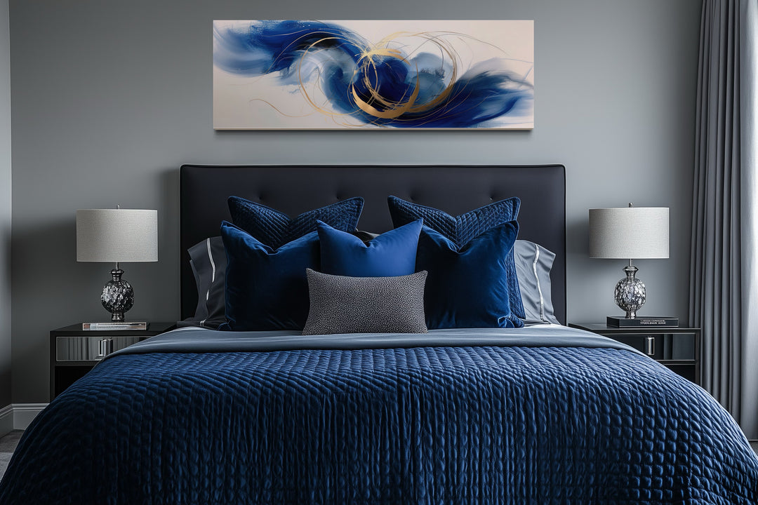 Blue, white, and gold minimalist abstract horizontal wall art hanging above a bed in a bedroom.