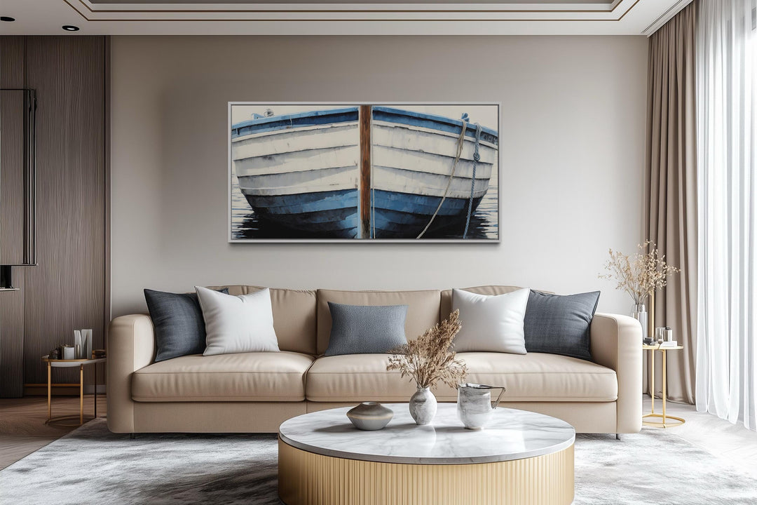 Blue and white rustic boat painting canvas wall art hanging above a beige sofa in a modern room.