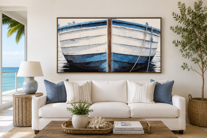 Large framed canvas wall art of a rustic blue and white boat hull above a white sofa.