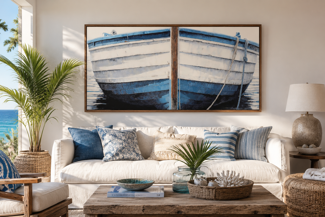 Blue and white rustic boat painting canvas wall art in a wooden frame above a white sofa.