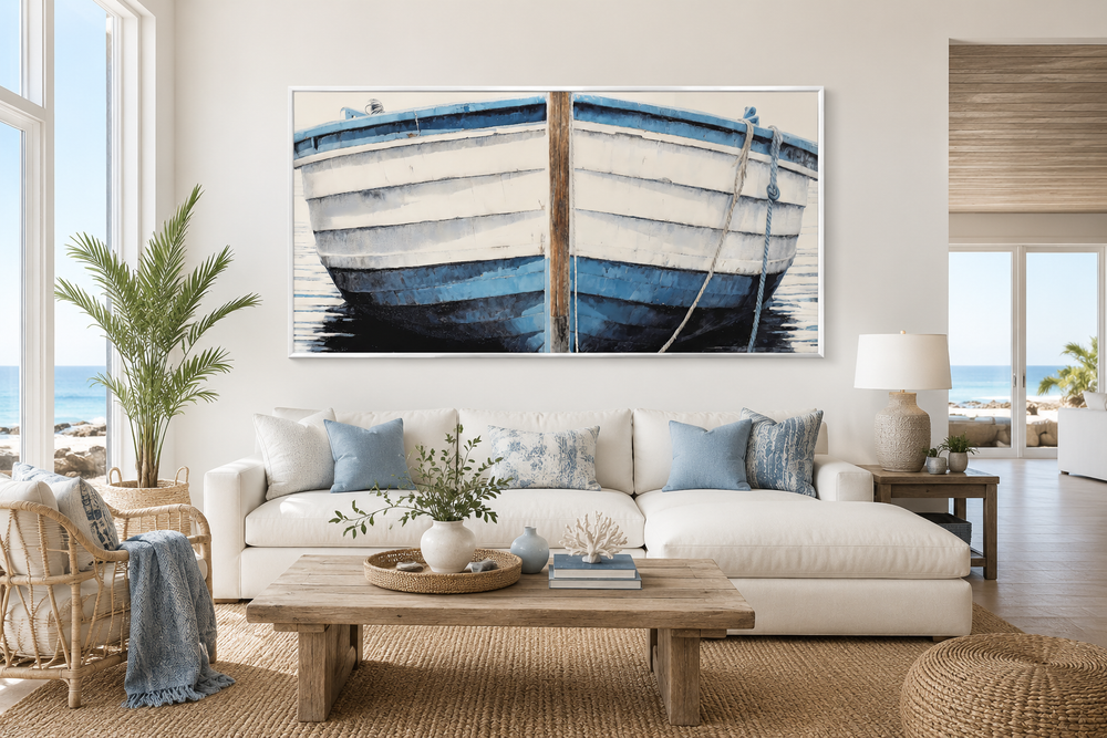 Large blue and white rustic boat painting canvas wall art above a white sofa in a coastal room.