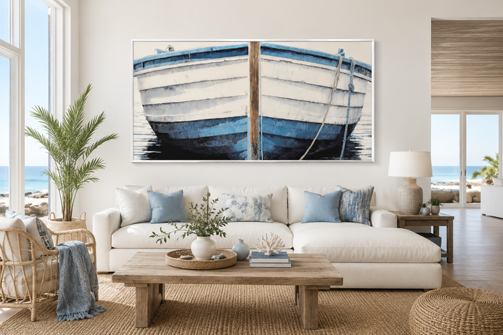 Large blue and white rustic boat painting canvas wall art above a white sofa in a coastal room.
