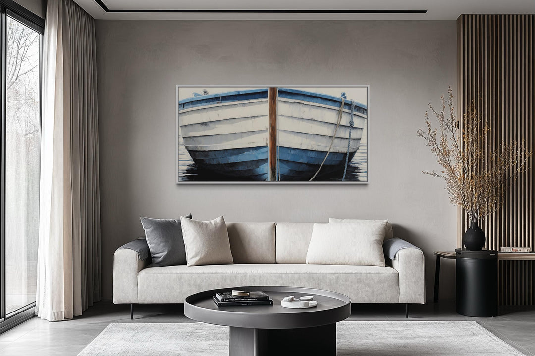 Blue and white rustic boat painting canvas wall art hanging above a modern sofa in a living room.