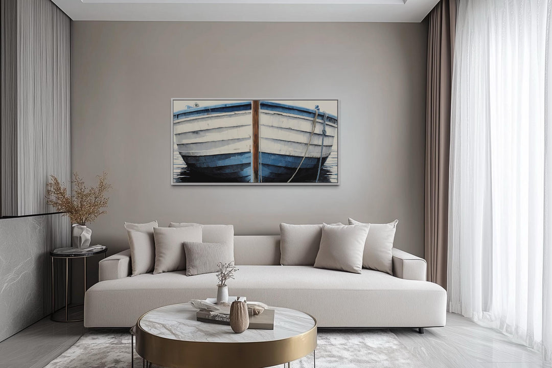 Blue and white rustic boat painting canvas wall art hanging above a modern sofa in a living room.