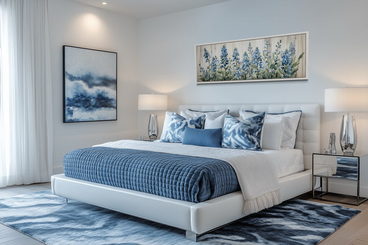 Blue wildflowers horizontal framed canvas wall art displayed above a white bed in a bedroom.