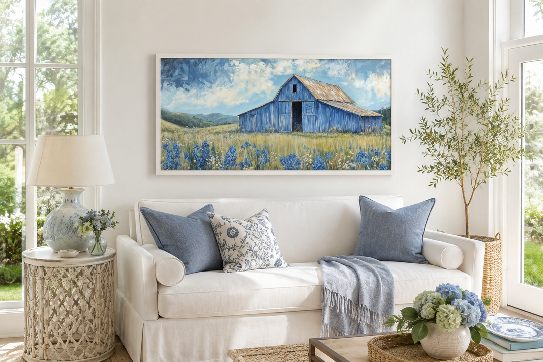 Blue barn and bluebonnets rustic framed canvas wall decor above a white sofa in a farmhouse living.