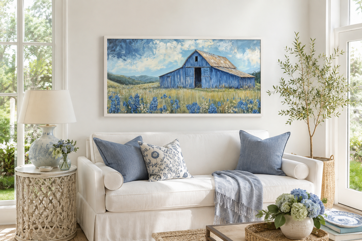 Blue barn and bluebonnets rustic framed canvas wall decor above a white sofa in a farmhouse living.