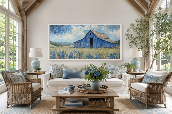 Blue Barn and Bluebonnets rustic framed canvas wall decor above a white sofa in a farmhouse room.