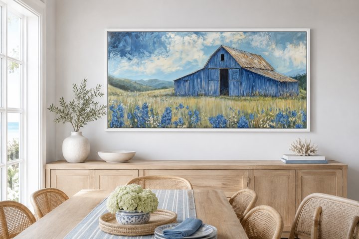 Blue Barn and Bluebonnets rustic framed canvas wall decor above a wooden sideboard in a dining room.