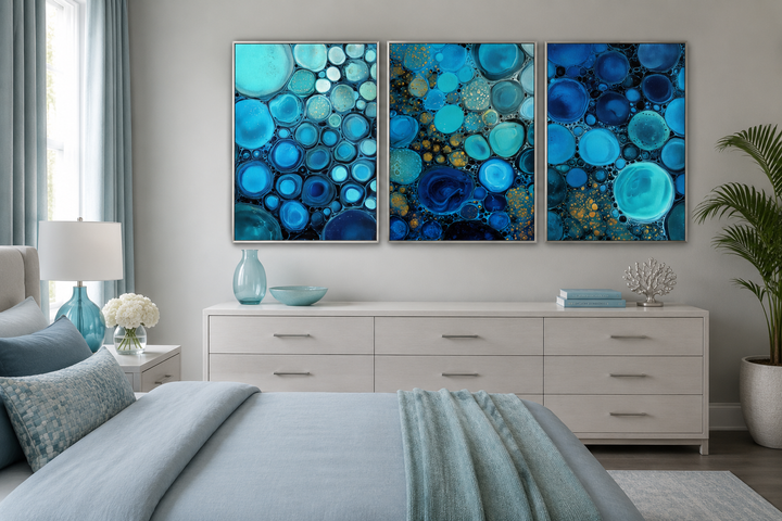 Three-piece abstract canvas set featuring blue, aqua, and navy bubble patterns above a dresser.