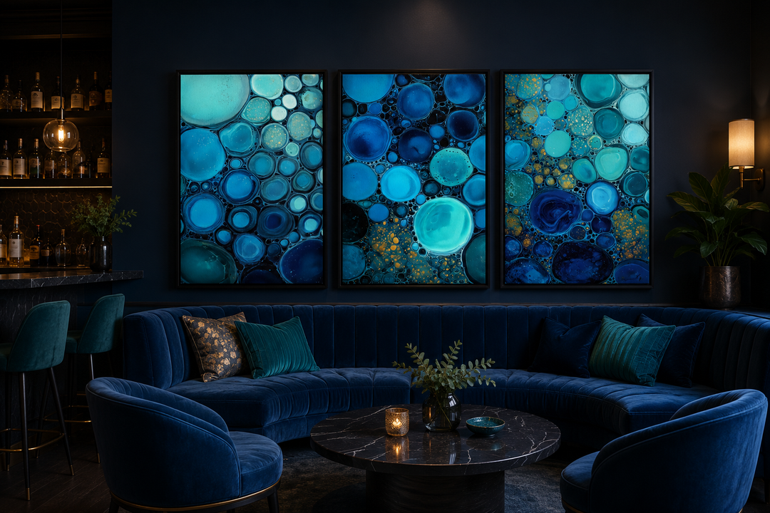 Set of 3 abstract canvas prints featuring blue, aqua, and navy bubble patterns on a dark wall.