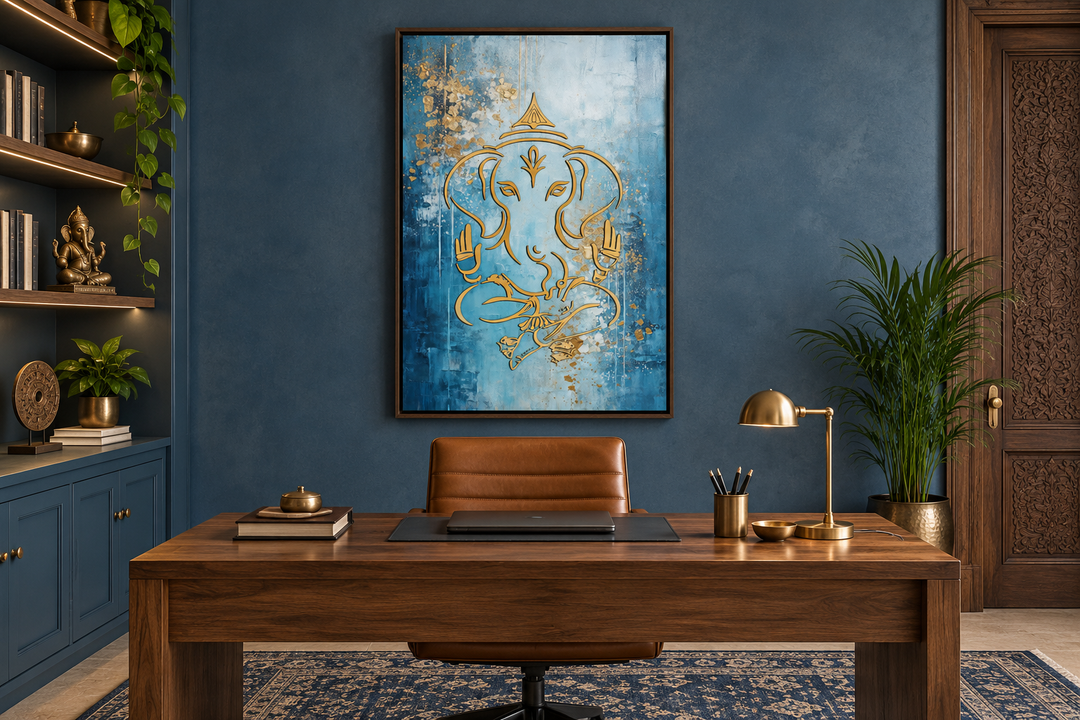 Blue and gold Lord Ganesha wall art in a black frame above a walnut desk in a modern office.
