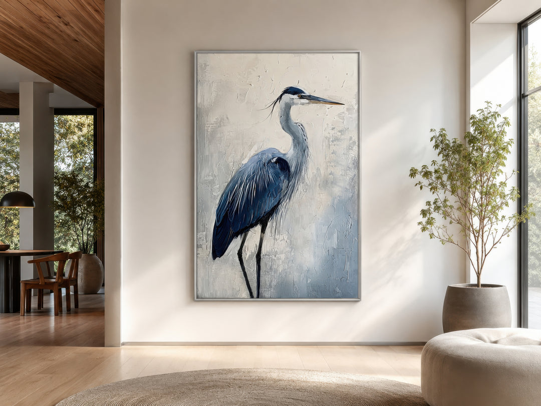 Vertical framed canvas wall art featuring an abstract blue heron painting in a modern living room.