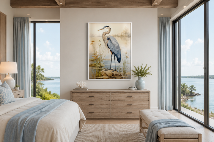 Framed vertical canvas wall art of a blue heron standing in reeds, hung above a wooden dresser.