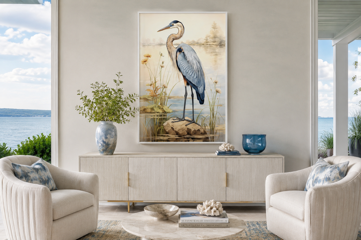 Framed vertical canvas wall art of a blue heron standing on a rock in a coastal landscape.
