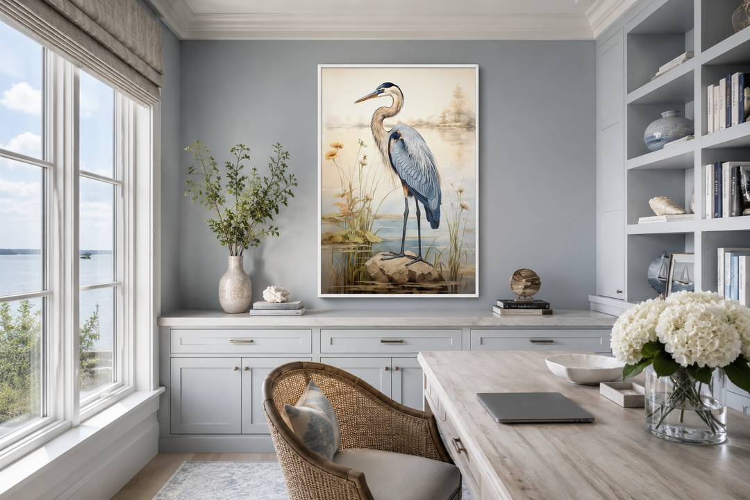Framed vertical canvas wall art of a blue heron standing on a rock in a coastal marsh setting.