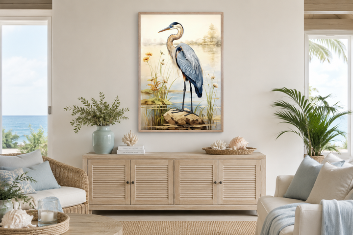 Framed canvas wall art of a blue heron standing in reeds, displayed above a wooden sideboard.