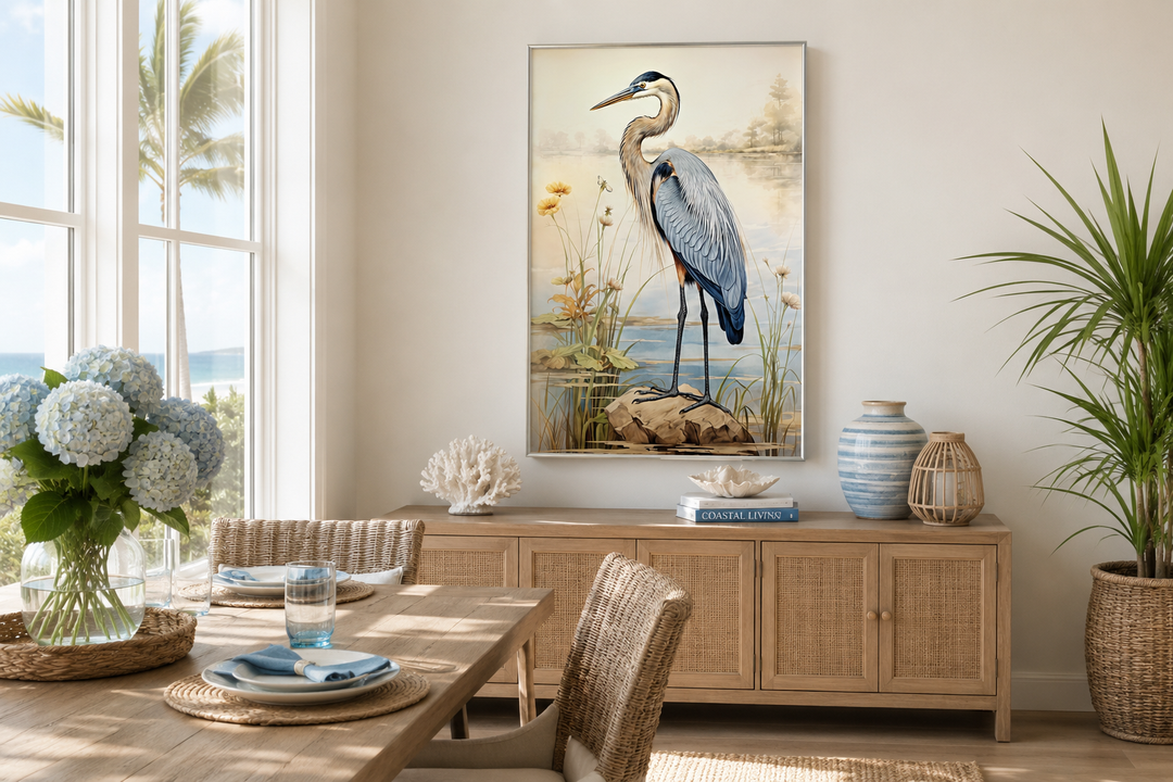 Framed vertical canvas wall art of a blue heron standing on a rock in a coastal landscape.