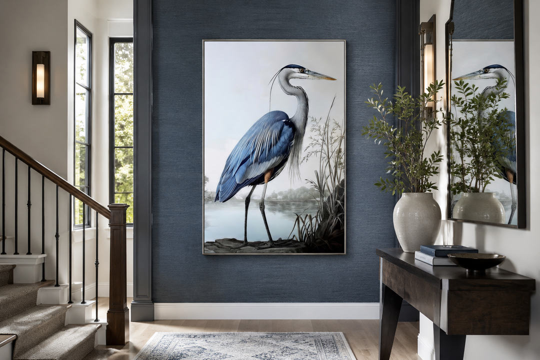 Framed canvas wall art of a majestic blue heron in a coastal setting on a dark blue textured wall.