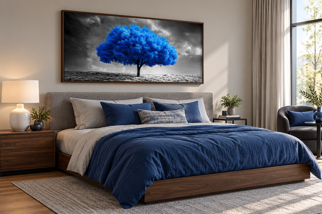 Blue tree on black and white background framed canvas wall art hanging above a bed in a bedroom.