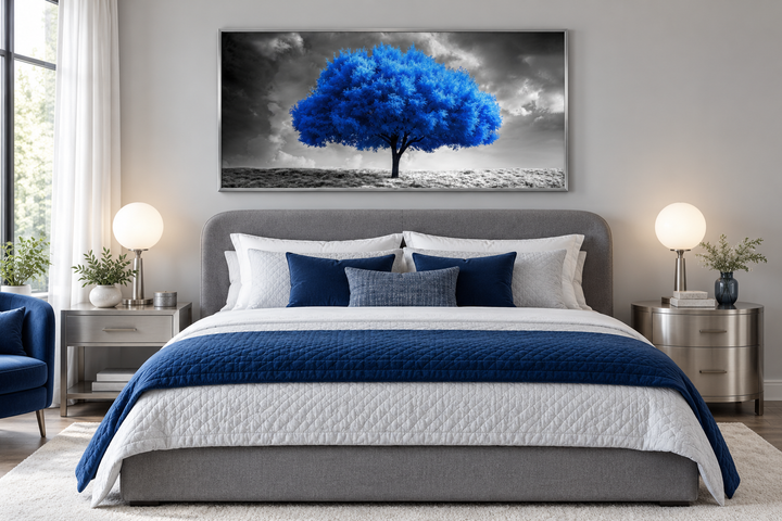 Blue tree on black and white background framed canvas wall art hanging above a bed in a bedroom.