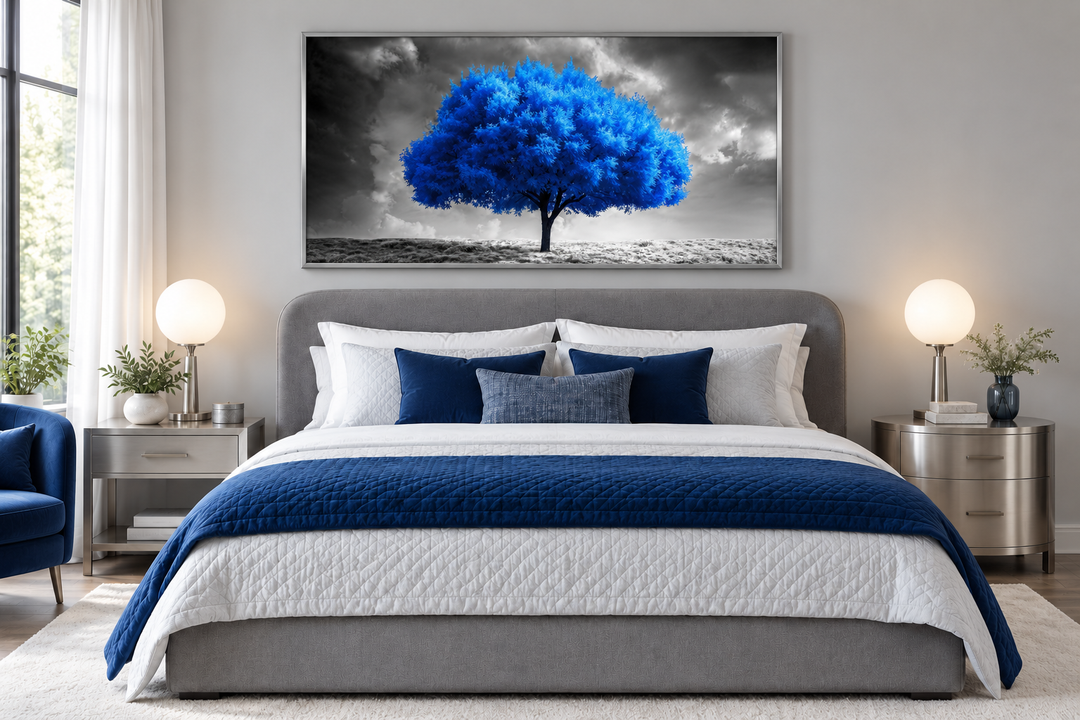Blue tree on black and white background framed canvas wall art hanging above a modern bed.