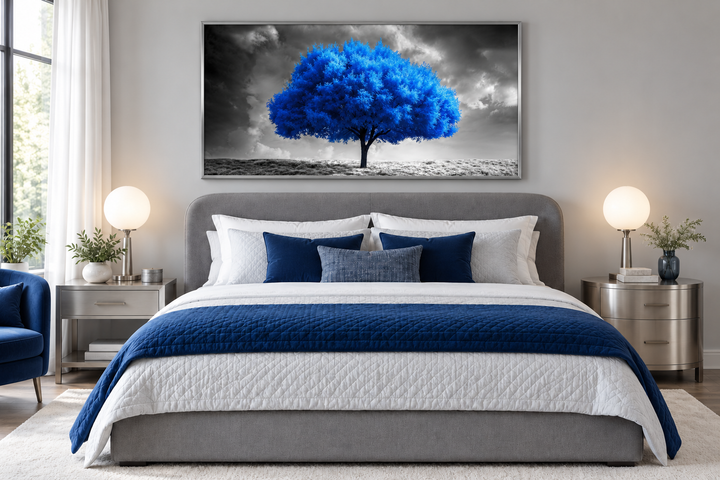 Blue tree on black and white background framed canvas wall art hanging above a modern bed.